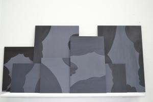 inclement series of paining displayed on shelf